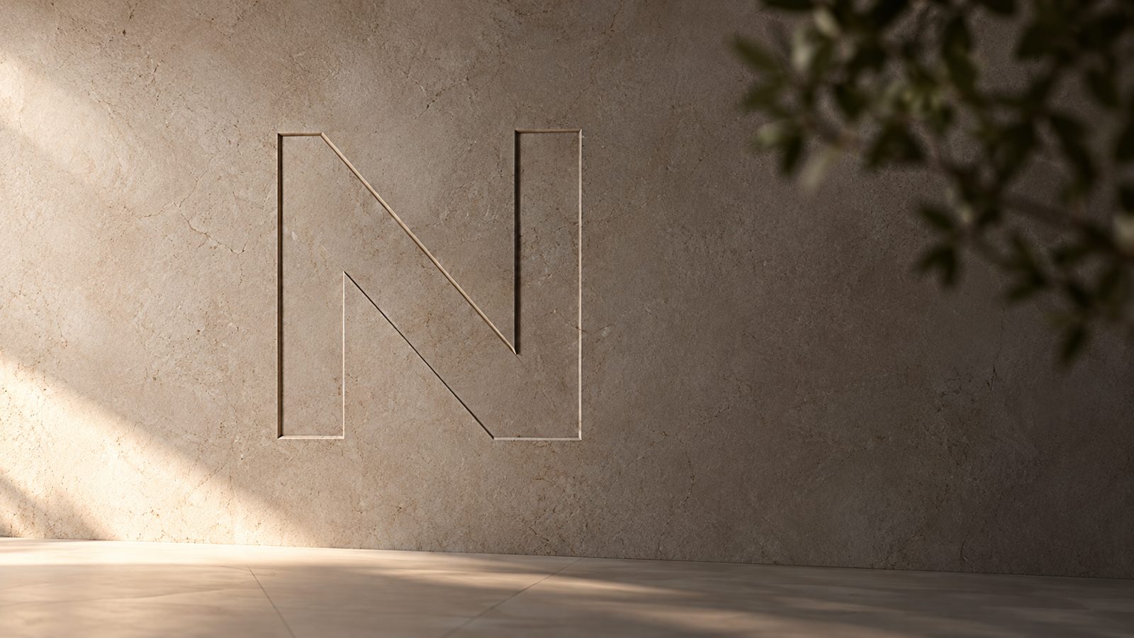 The StudioN N carved into a stone wall, in soft afternoon light